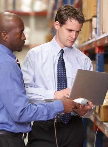 Man using laptop in team meeting